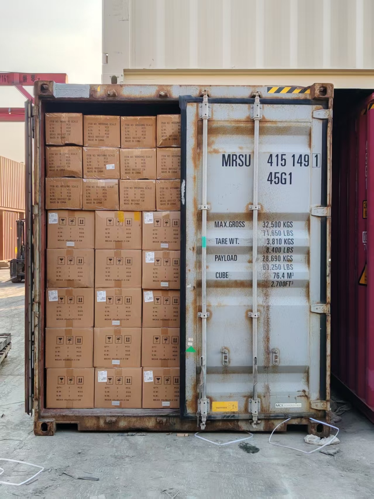 Open freight container fully loaded with boxed medical equipment and supplies