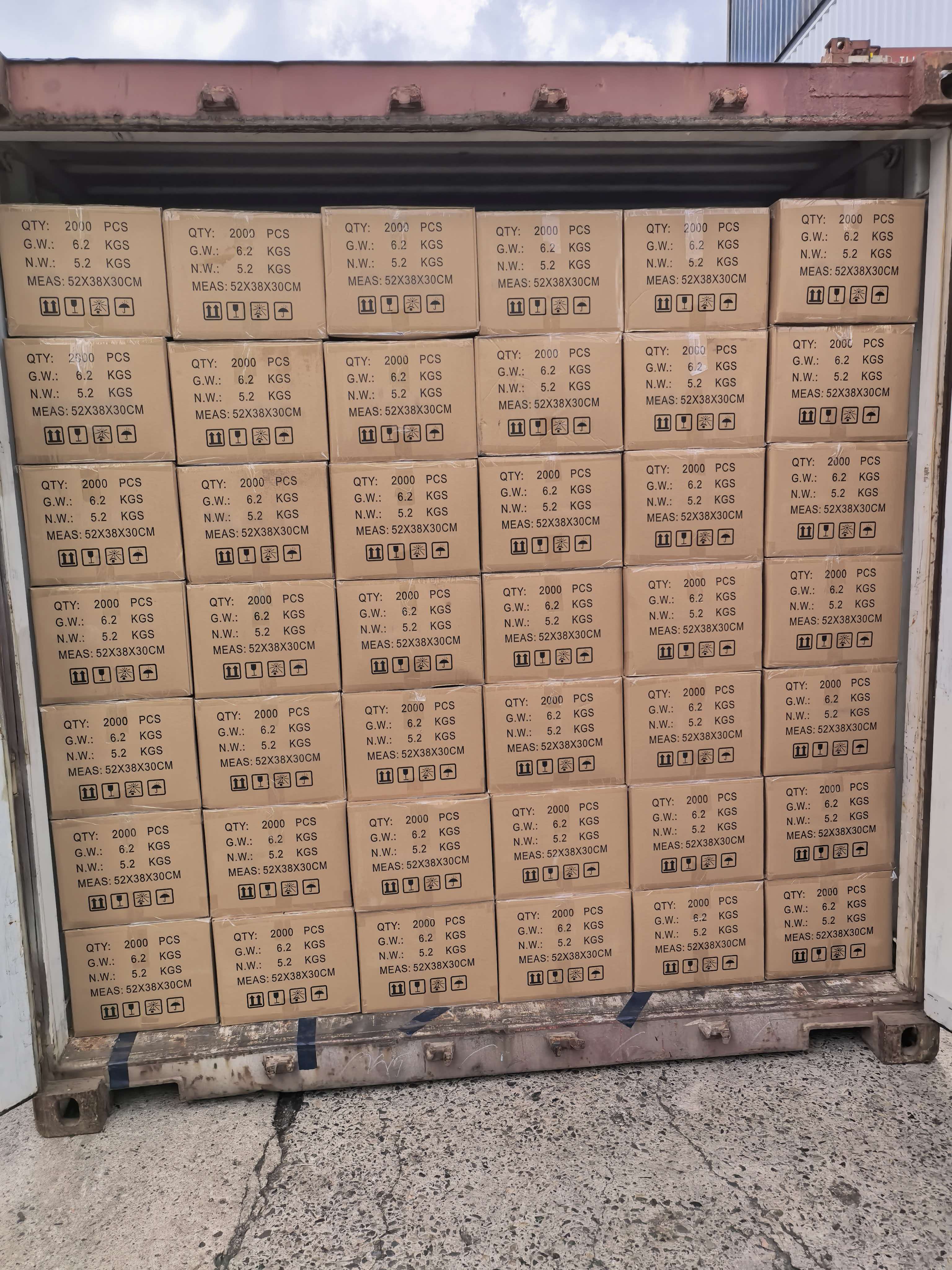 Fully packed export container with rows of medical supply cartons stacked from floor to ceiling