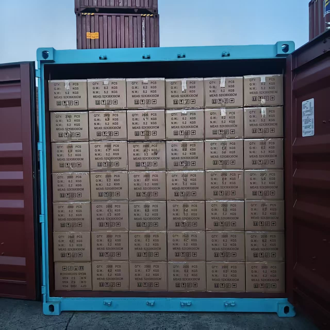Open export container packed floor to ceiling with cartons of medical equipment and supplies