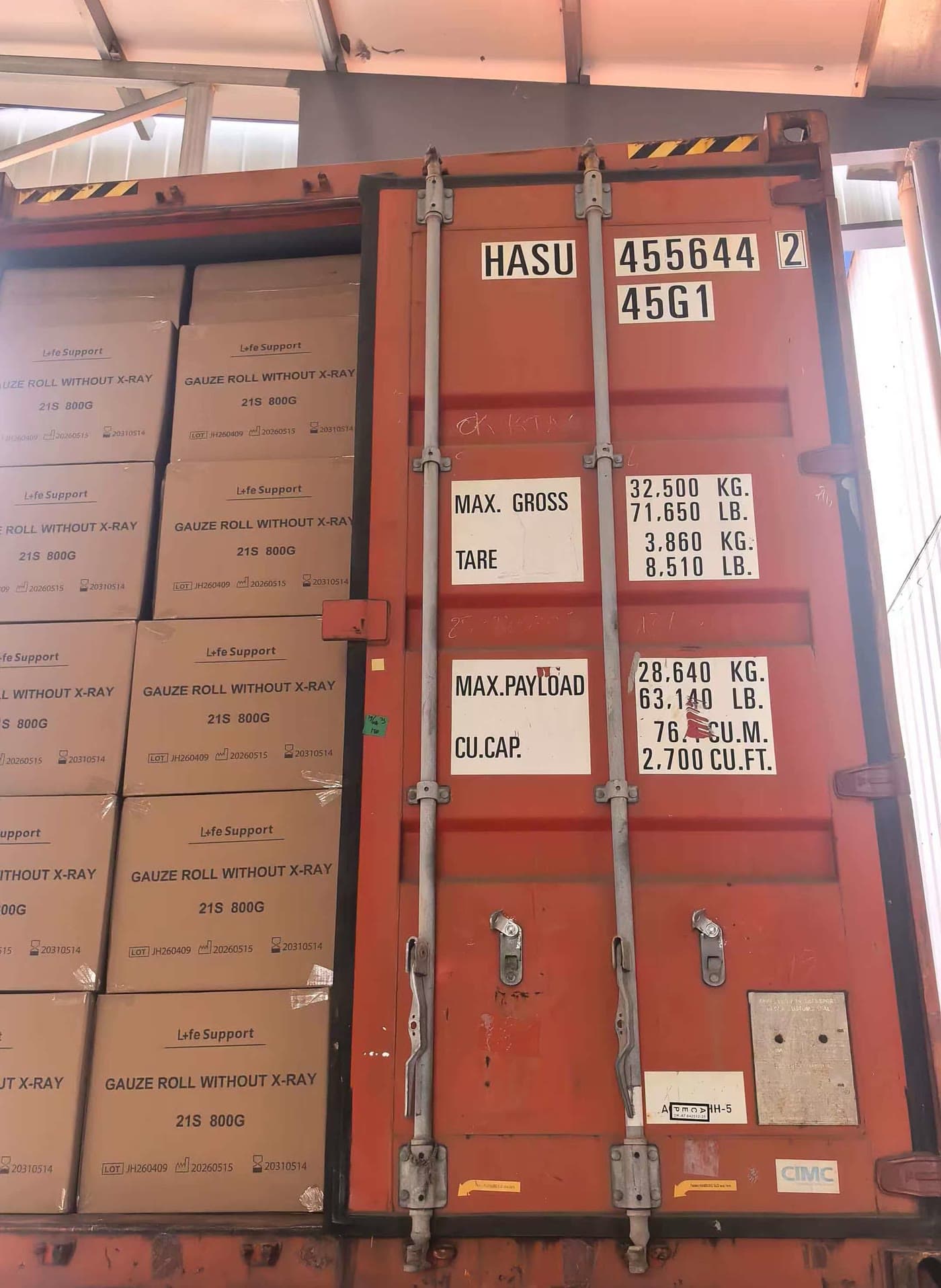 An orange container loaded with cartons of medical supplies, ready to close
