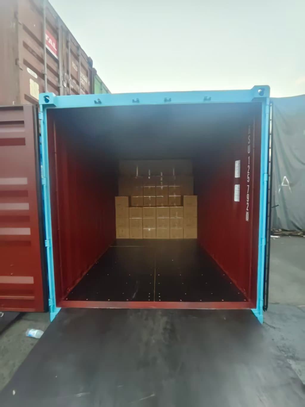 Container in the early stages of loading with the first cartons of medical supplies stacked at the rear