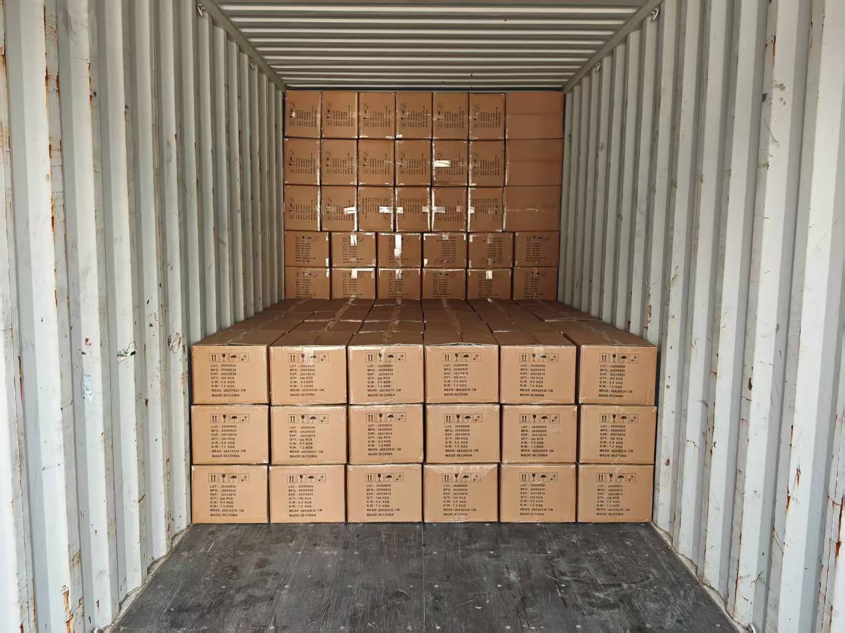 Cartons of medical equipment and supplies stacked inside a container during loading