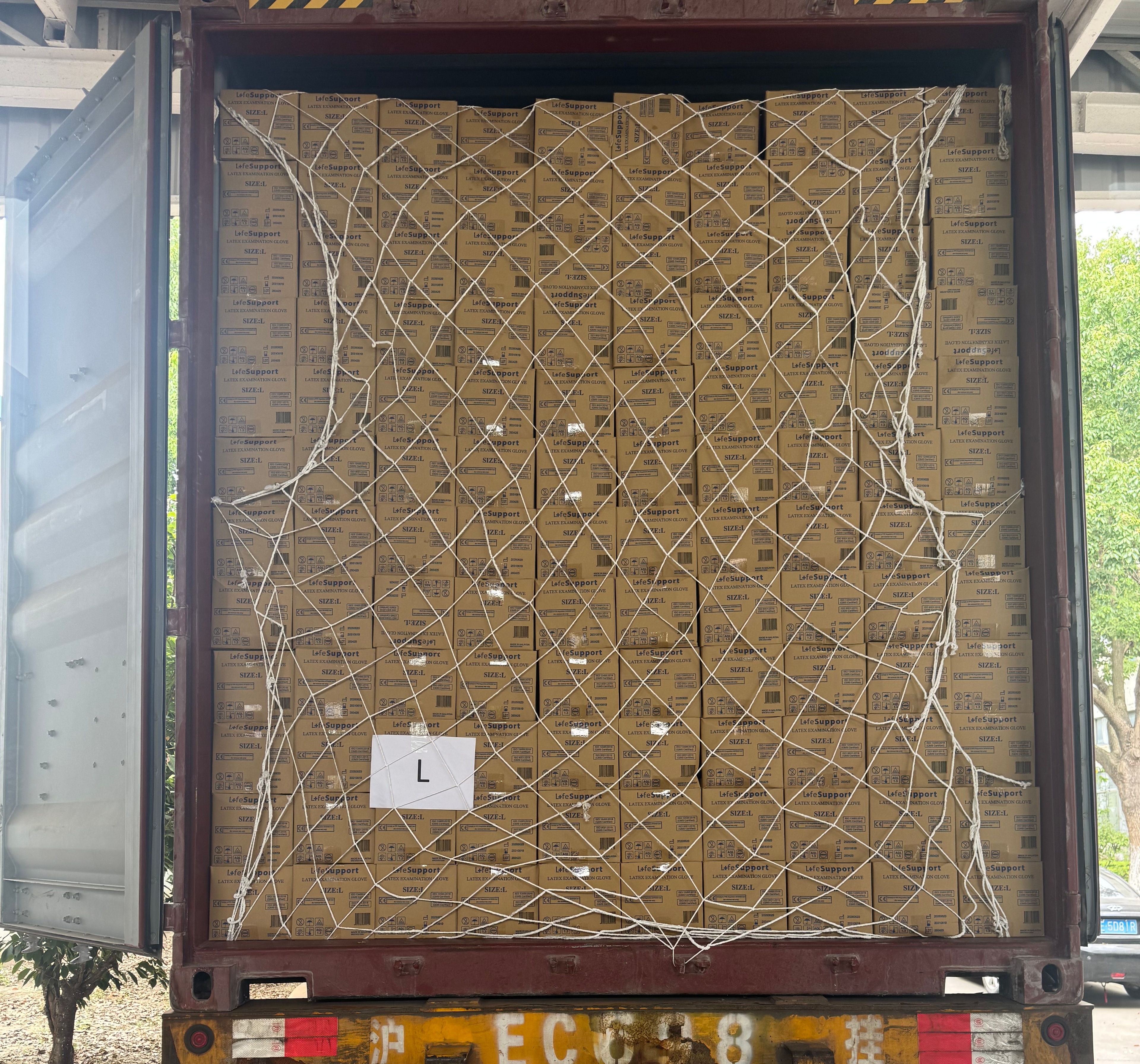 Container of medical equipment and supplies secured with a cargo net before the doors are closed