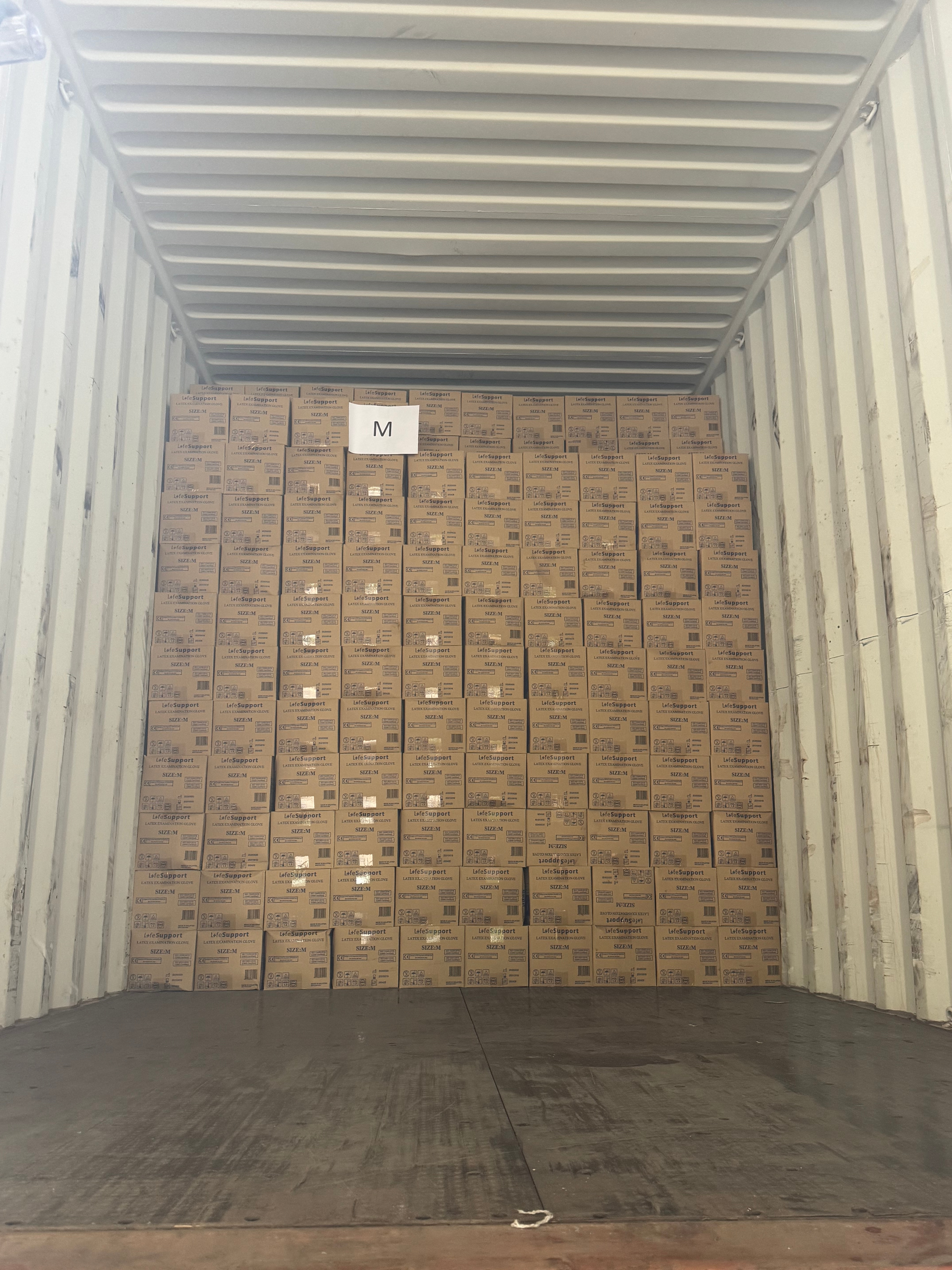 Export container packed floor to ceiling with cartons of medical equipment and supplies